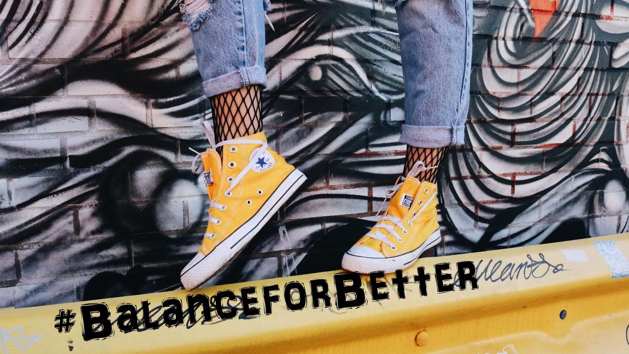 International Women's Day blog #BalanceforBetter woman's feet balancing on a barrier