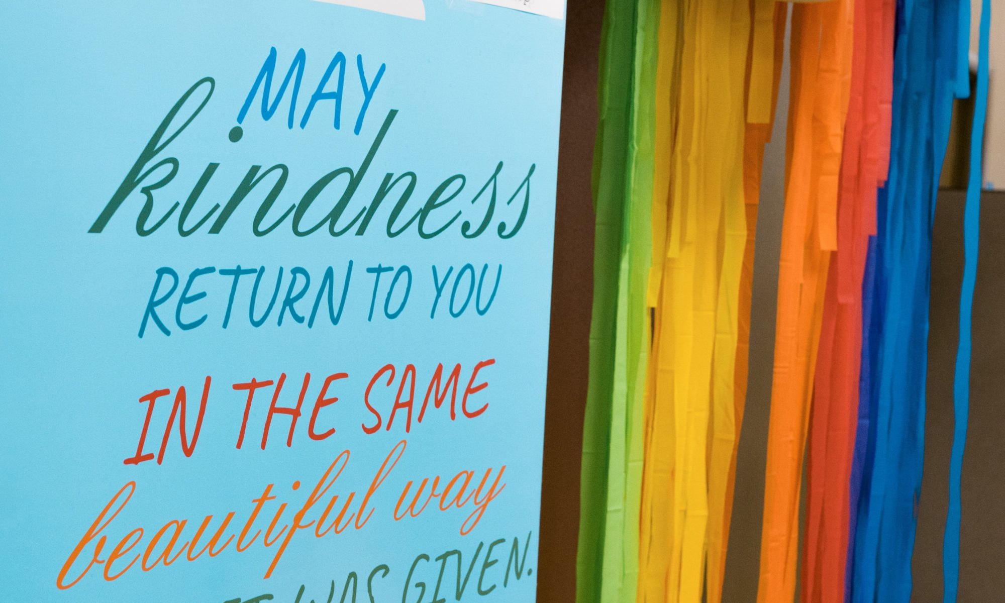 sign reading kindness with rainbow to illustrate blog on the importance of kindness